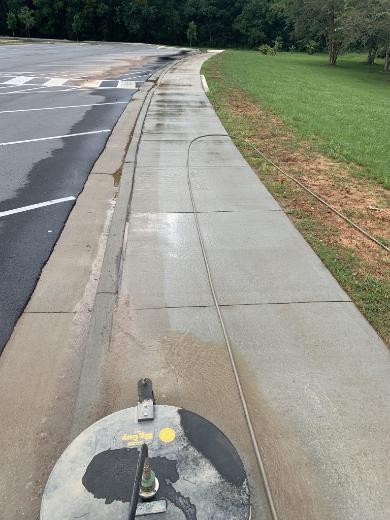 Pressure Washing a sidewalk