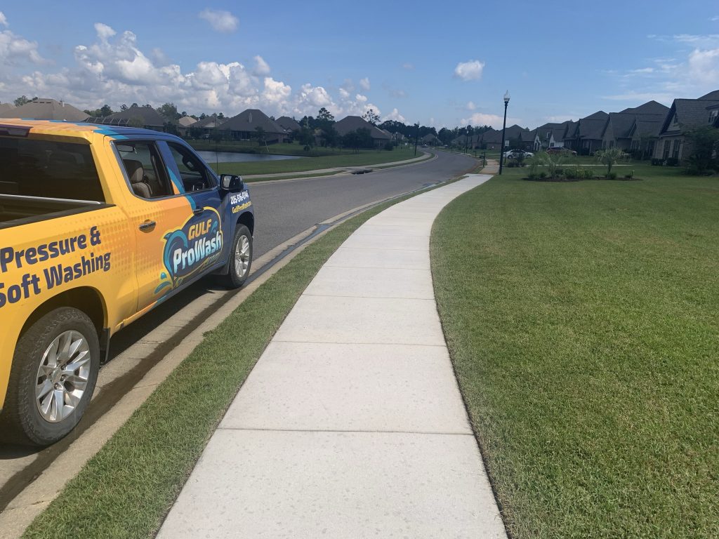 Pressure washing a sidewalk in Gulf Shores